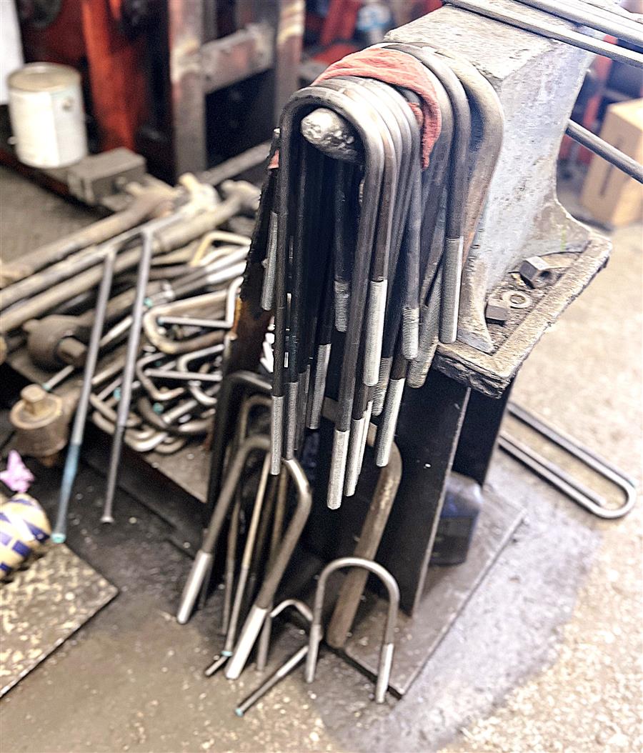 Extensive inventory of custom heavy-duty U-bolts organized on racks